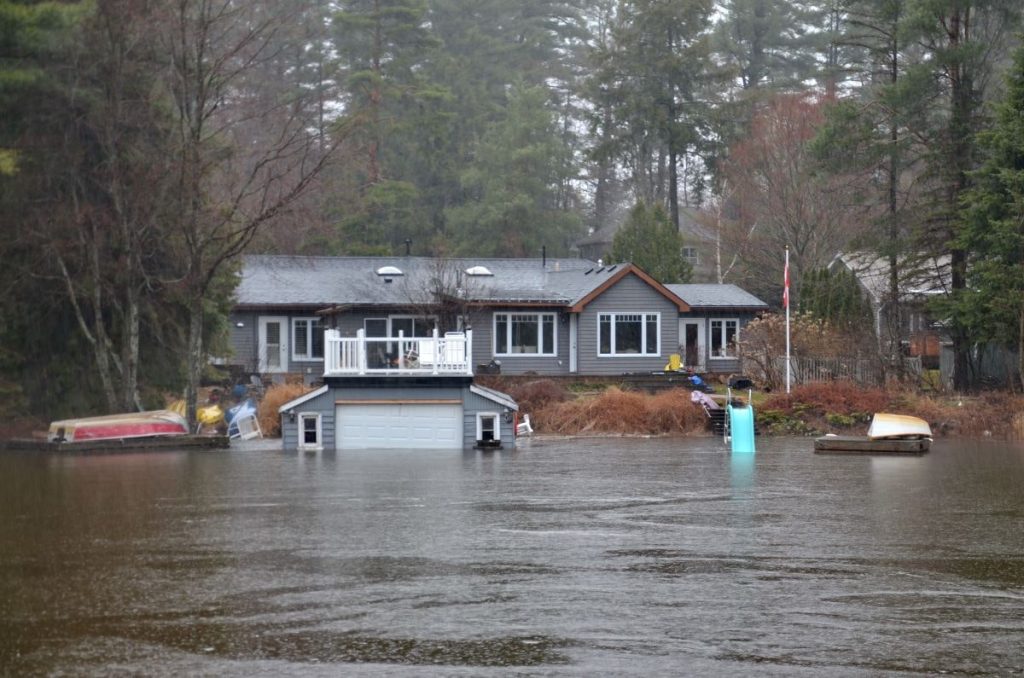 Flooded Street in front of a home. PuroClean can help with flood restoration