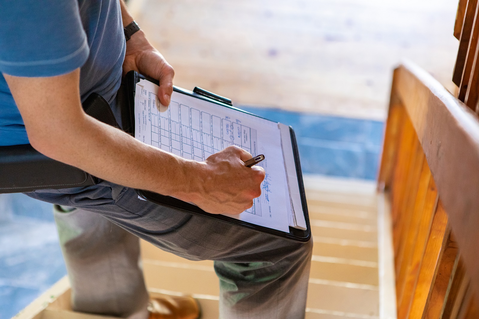 man writing on a checklist | restoration services in Greensboro