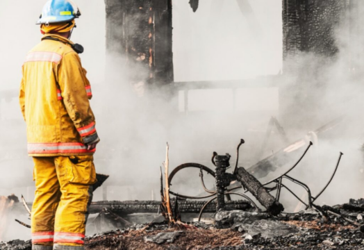 fire professional inspecting a house fire