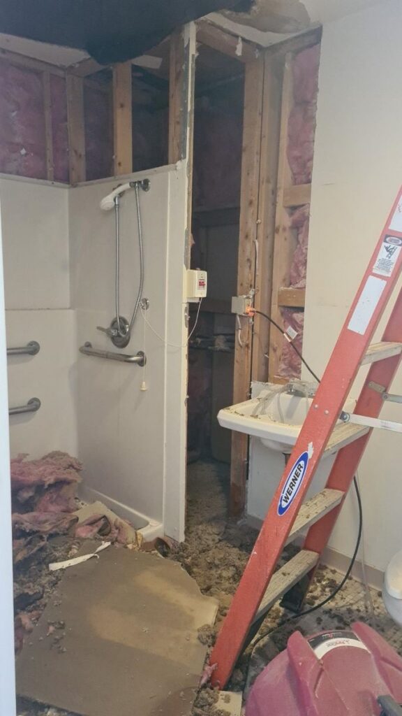 Water damage in bathroom caused by burst pipe.