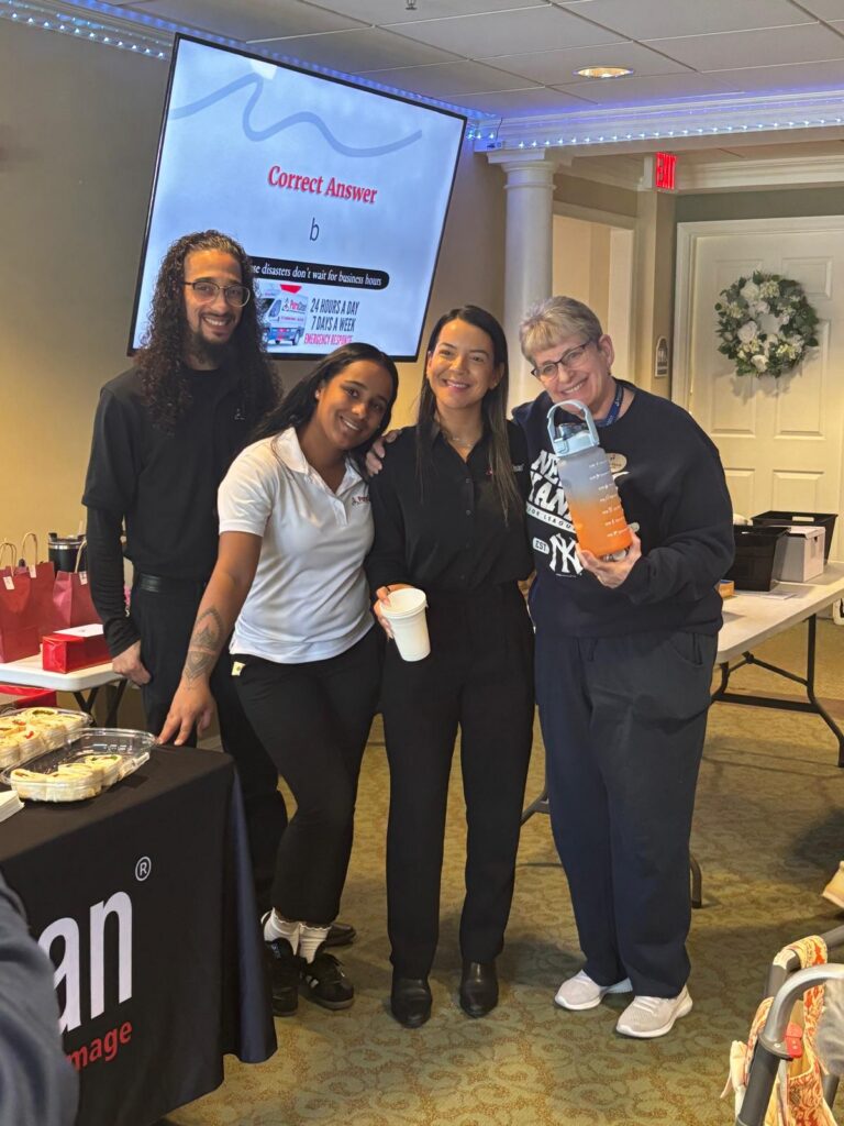 PuroClean of Livingston staff giving gifts during assisted living visit – property restoration Livingston NJ