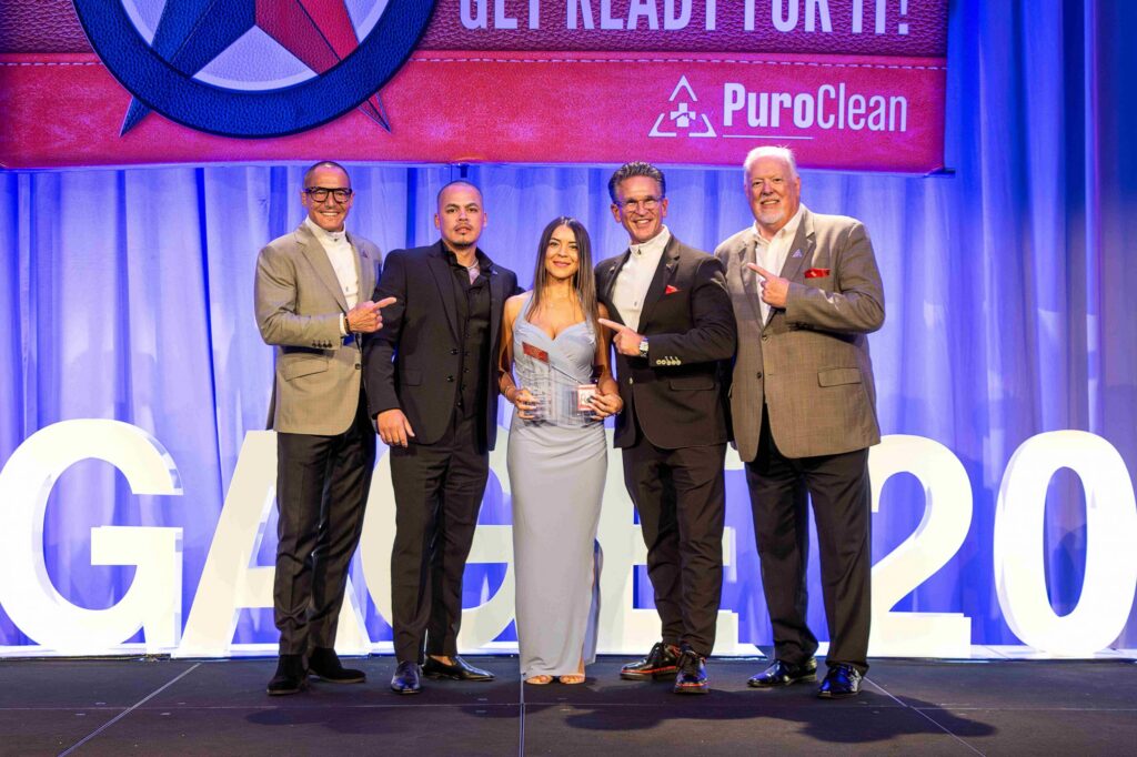 PuroClean NJ owners receiving Franchise of the Year 2024 award