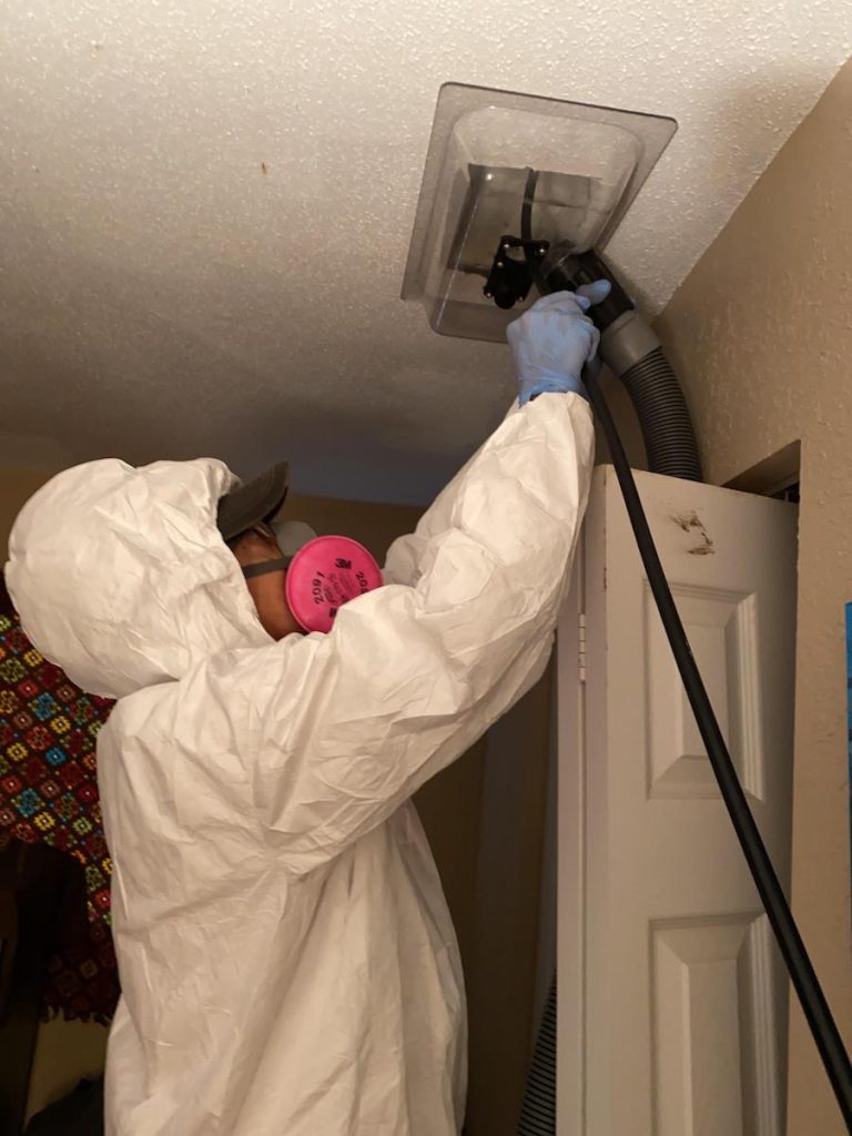 PuroClean Volunteer team technician cleaning bedroom and hallway, Helping the community