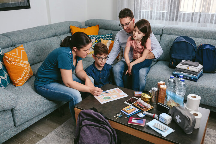 Family sitting on a couch creating a tornado emergency plan