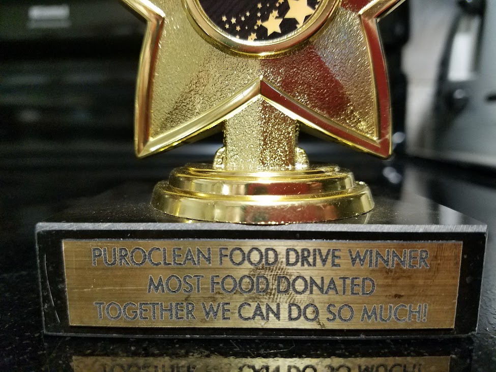A photo of the trophy given to the insurance agency that collects the most food