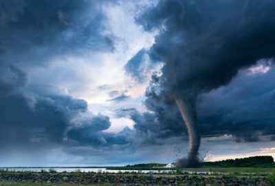 A tornado is formed when a column of air extends from a thunderstorm and comes in contact with the ground, supporting an updraft.