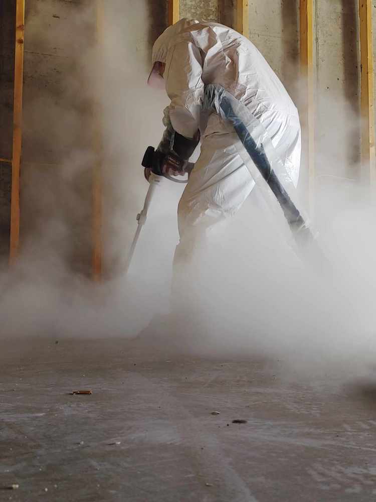 A technician conducts dry-ice blasting on a fire damaged home