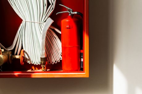 Fire extinguisher and pipeline in red safety box