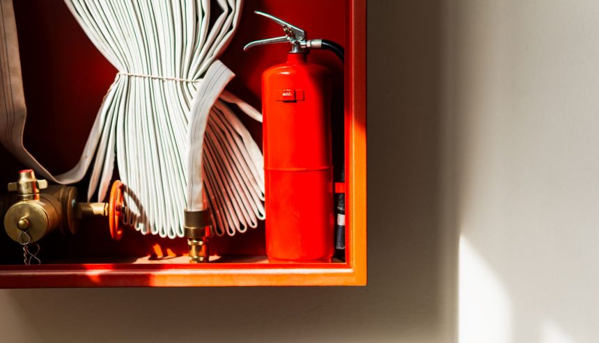 Fire extinguisher and pipeline in red safety box