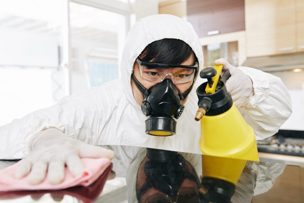 Technician cleaning kitchen counter for sanitization