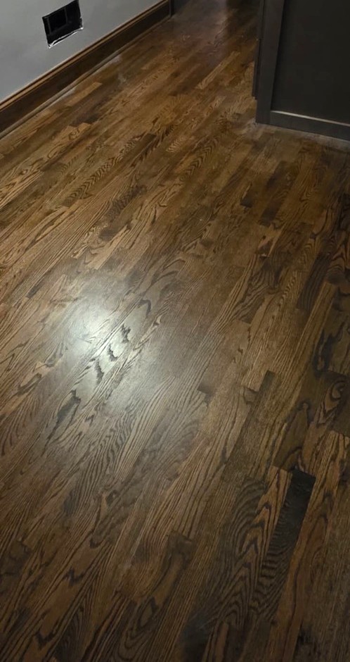Restored dark-stained hardwood floor after PuroClean of East Cobb water damage restoration in Johns Creek
