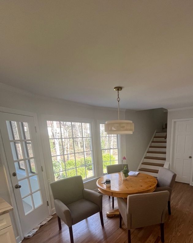 Fully restored breakfast nook with dining table and pendant light after PuroClean of East Cobb fire damage restoration in Peachtree Corners