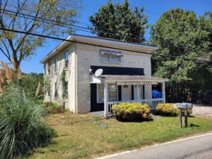 The former Winston Bank building in Winston, Georgia — the white brick landmark of an unincorporated Douglas County community in the Dog River watershed