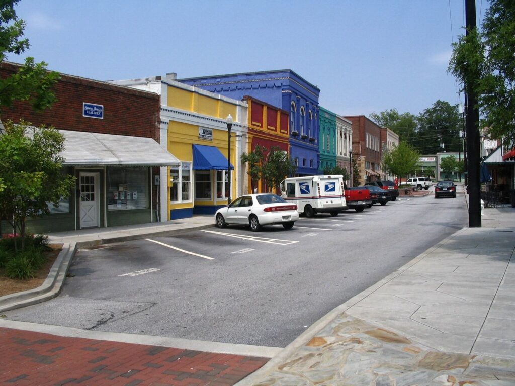 Colorful historic storefronts on a main street in Olde Town Conyers, Georgia — the historic commercial district at the heart of the city