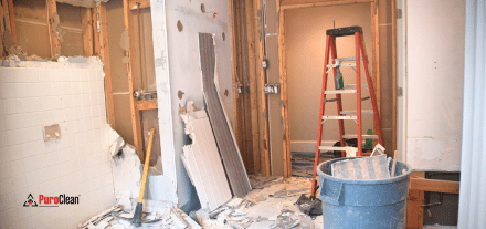property reconstruction image with ladder, trash can and partial walls.