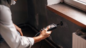 Professional performing moisture testing in McLean to detect hidden dampness and prevent water damage restoration