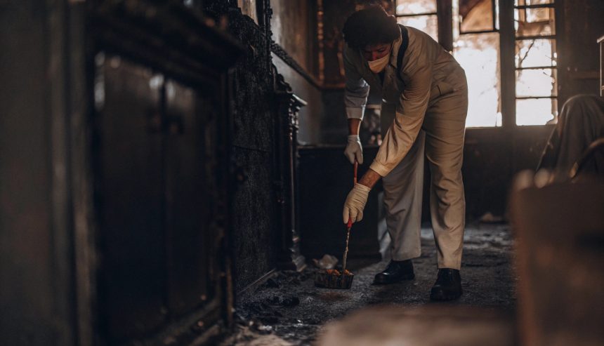 Technician cleaning soot during fire damage restoration in McLean VA