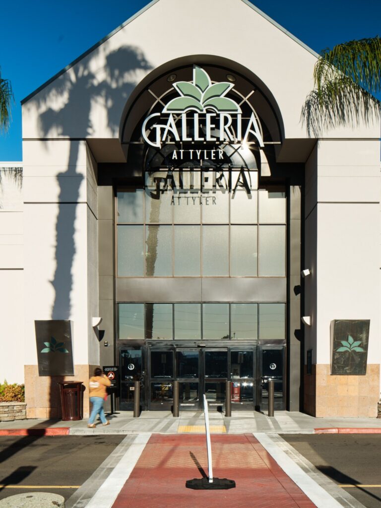 Main entrance of Galleria at Tyler mall with large sign, glass