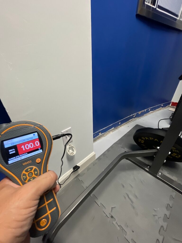 Checking for water in the flooded basement.