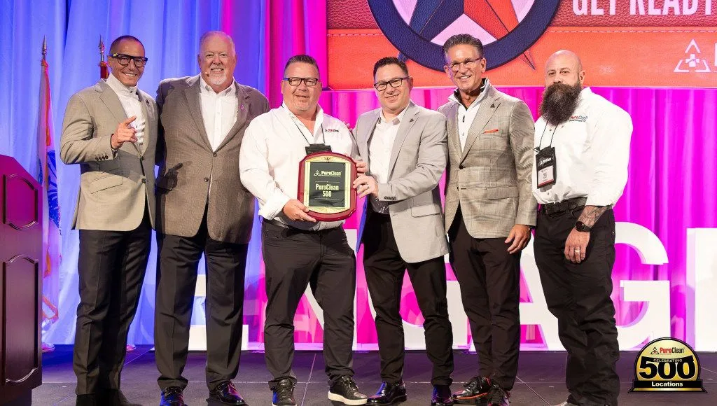 PuroClean leadership receiving an award for the PuroClean 500th Location