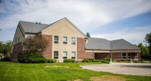 Huber Heights City Hall building - A modern brick and tan building with a gray roof stands on a green lawn