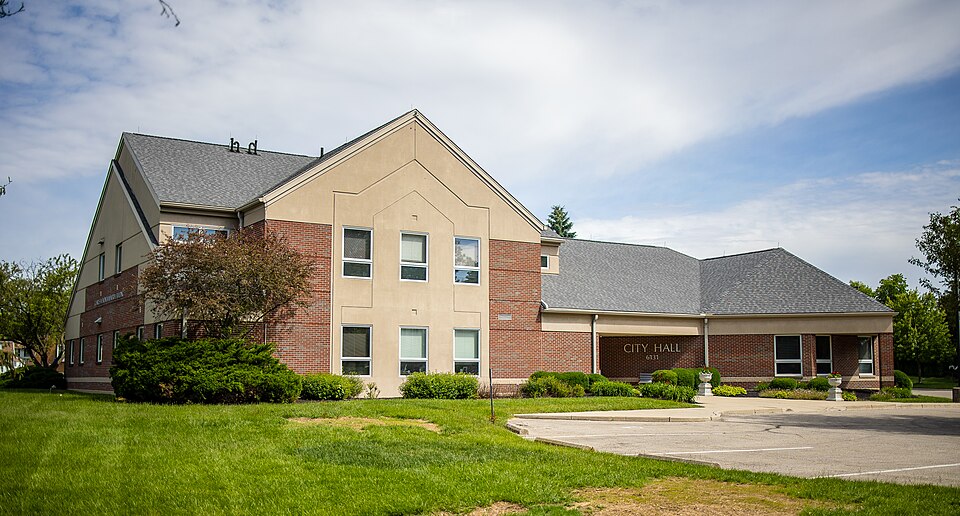 Huber Heights City Hall building - A modern brick and tan building with a gray roof stands on a green lawn