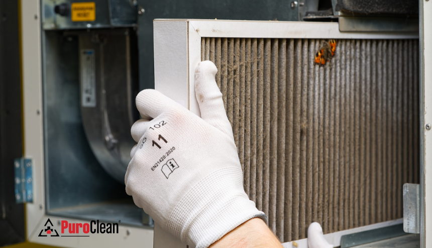 close up of HVAC filter being chnaged out, preventing water damage from hvac system