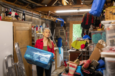 woman organizing a cluttered garage