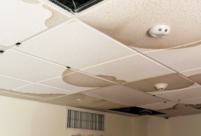 signs of mold on commercial ceilings - dark spots on sagging ceiling tiles