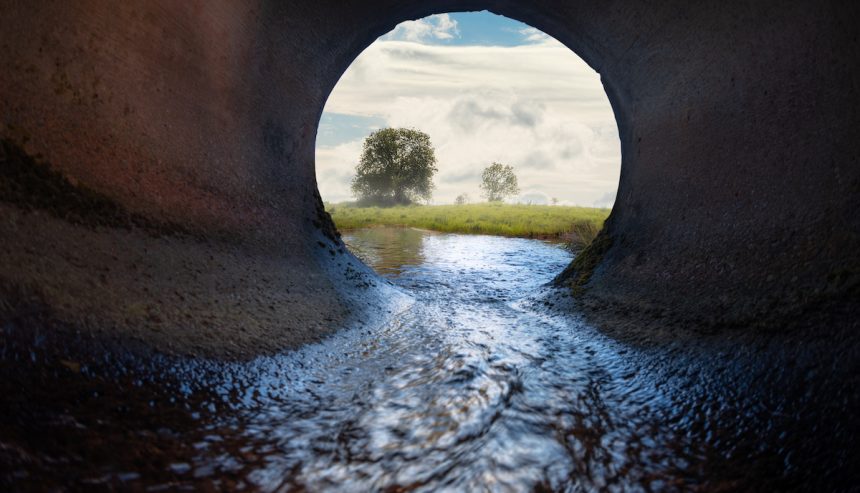 Black water flowing out of sewage system.