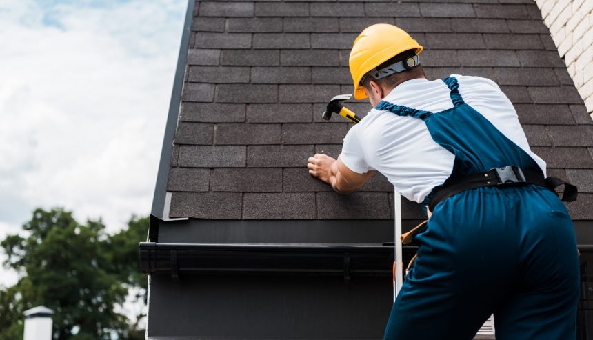 Handyman repairing water-damaged areas in a home