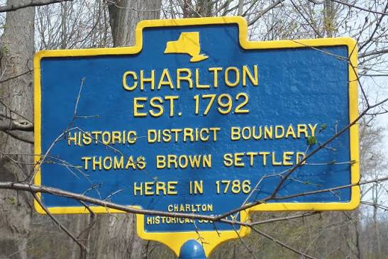 A blue and yellow historical marker for Charlton, New York, established 179