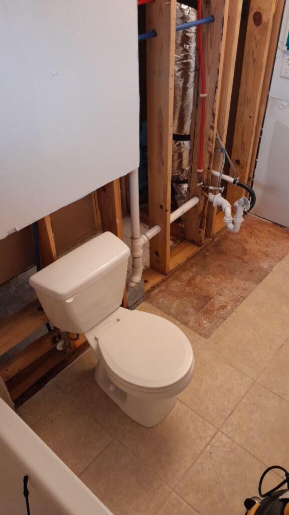 Mold growth was revealed beneath the tiles in a bathroom.