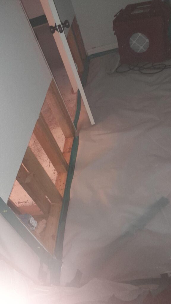 Contaminated drywall was removed in a room.