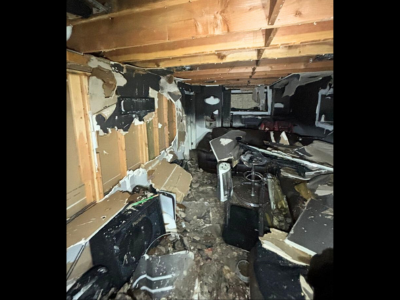 Basement destroyed by fire with collapsed walls, debris, and heavy soot damage, requiring professional smoke damage restoration to restore safety and structure.