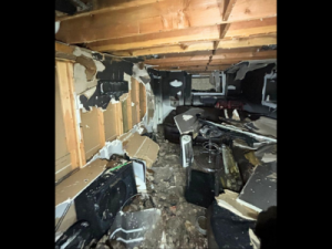Basement destroyed by fire with collapsed walls, debris, and heavy soot damage, requiring professional smoke damage restoration to restore safety and structure.