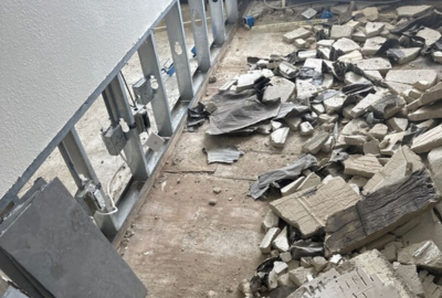Fire damage restoration in Orland Park showing tile debris, exposed framing, and post-fire demolition cleanup in progress.