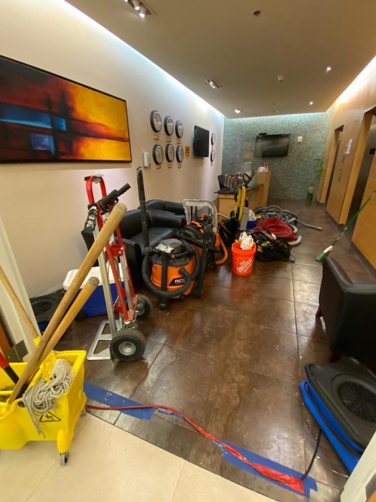 Commercial lobby undergoing water damage cleanup with professional restoration equipment.