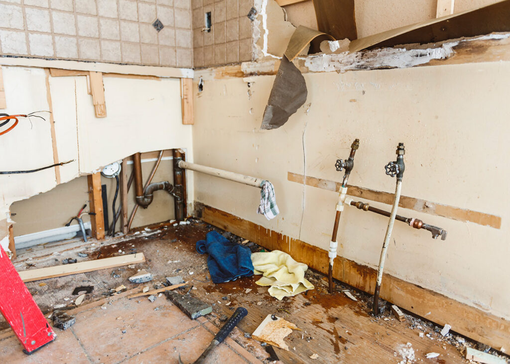 water damage restoration professionals working inside flooded home Ormond Beach Florida