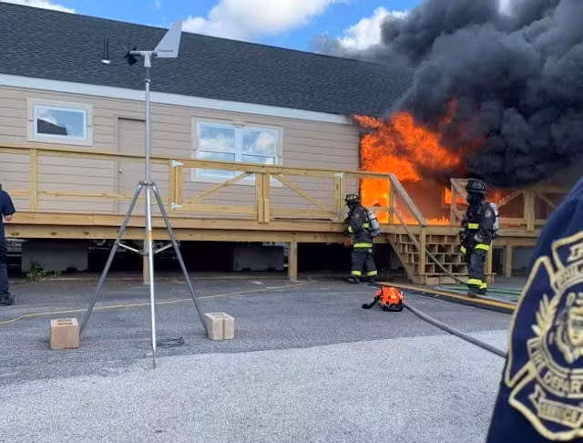 Firefighters confirming a home is safe for inspection after extinguishing flames