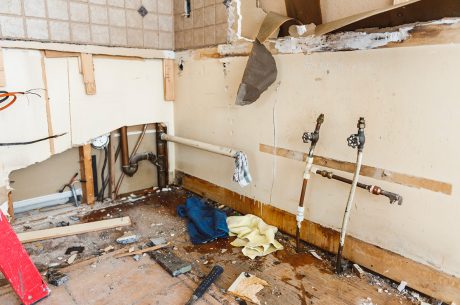water damage restoration professionals working inside flooded home Ormond Beach Florida