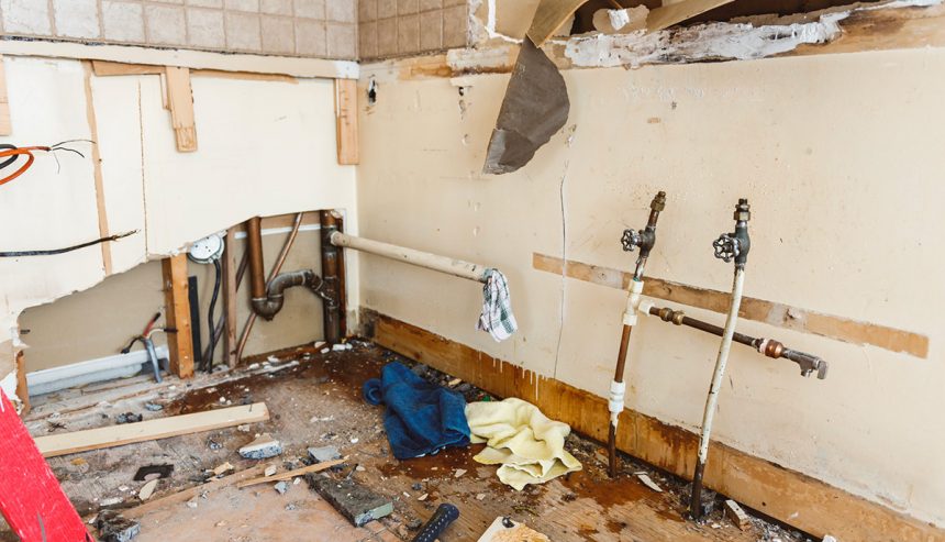 water damage restoration professionals working inside flooded home Ormond Beach Florida