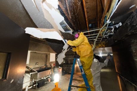 Professional restoration technician using a high powered air scrubber and thermal camera in an Ormond Beach FL home