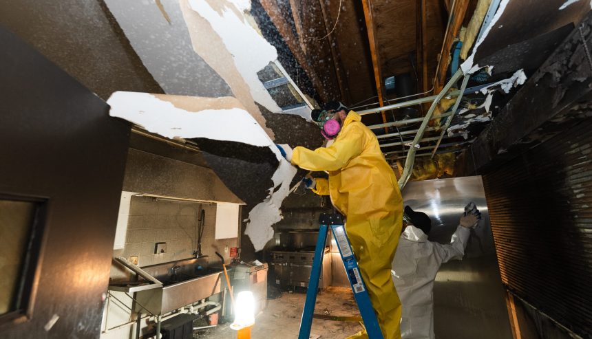 Professional restoration technician using a high powered air scrubber and thermal camera in an Ormond Beach FL home