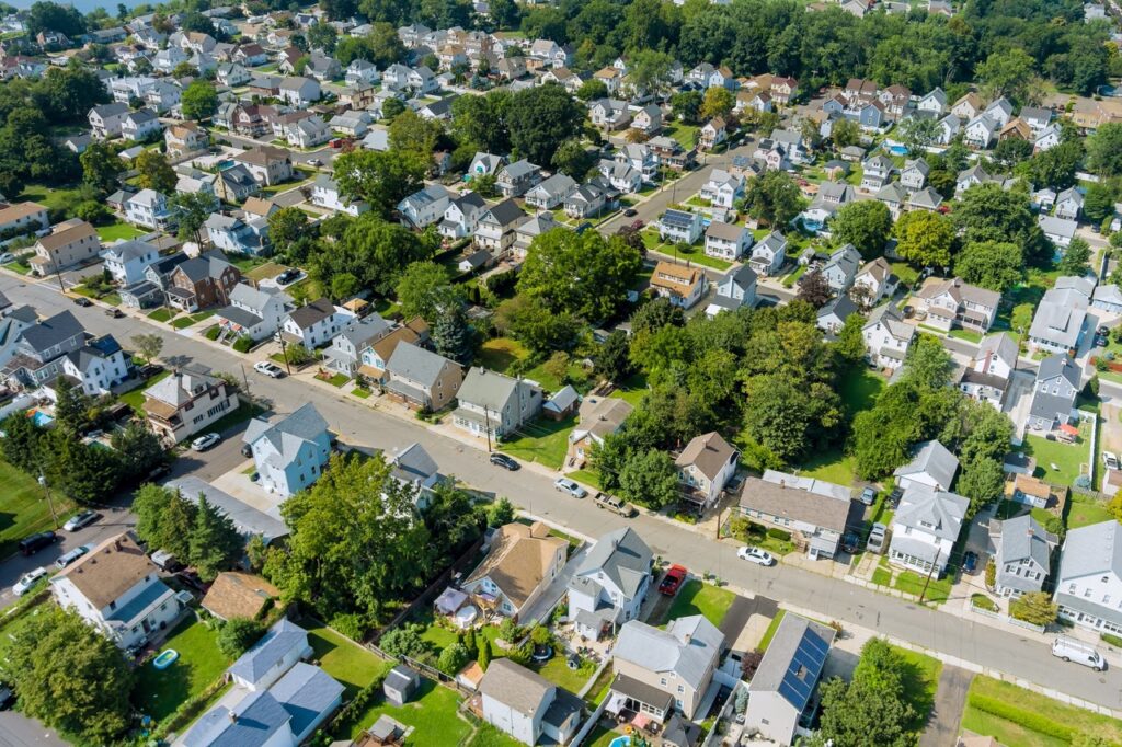 Aerial view of a densely packed residential East Brunswick, New Jersey, neighborhood with single-family homes, tree cover, and suburban street layout—ideal for analyzing flood-prone zones or planning local infrastructure.