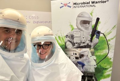 Smiling professional in protective gear providing safe Hoarding Cleanup and Biohazard Restoration services for a clean, healthy home.