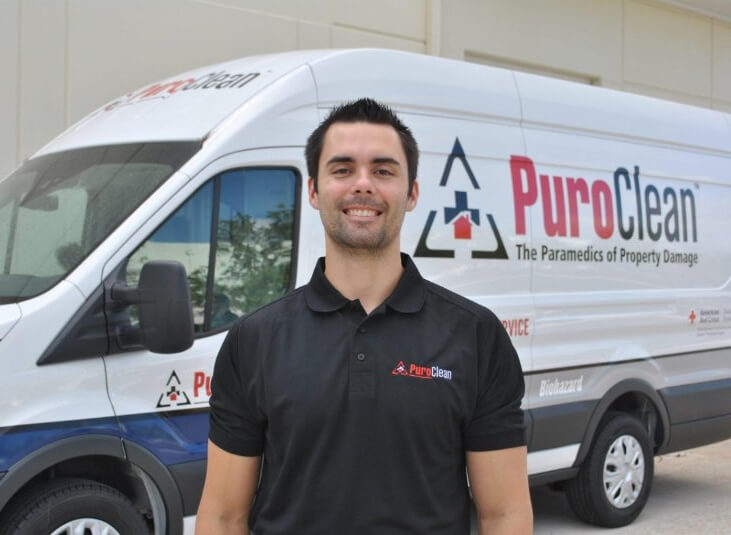 puroclean van behind the smiling staff smoke restoration company