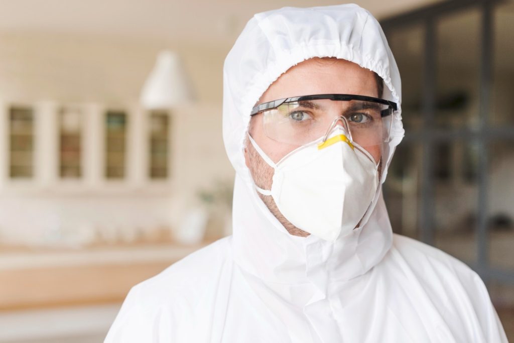 Man wearing hazmat suit and mask