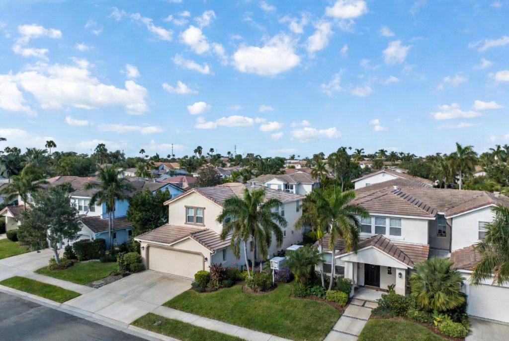 Peaceful and well-maintained suburban neighborhood in Fort Lauderdale South Florida with palm trees and manicured lawns


