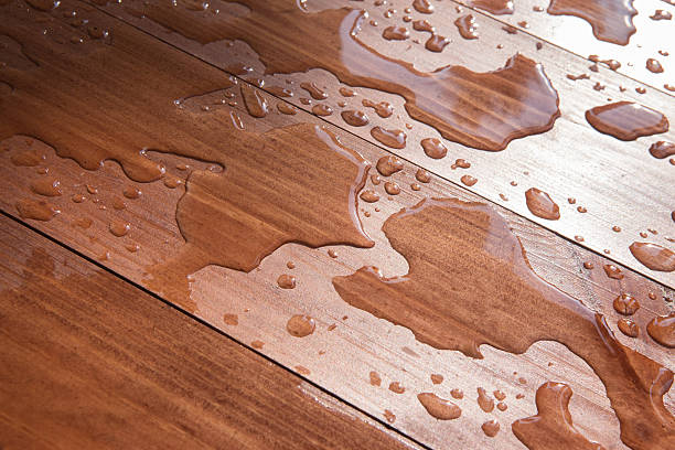 protect hardwood floors from water damage. water drops on wooden board closeup
